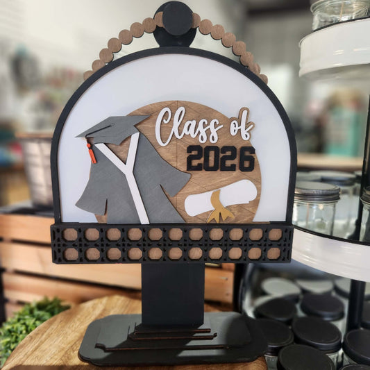 Decorative sign with 'Class of 2026' design on a stand.