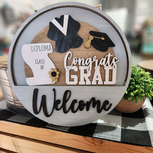 Decorative sign with graduation-themed elements on a blurred background