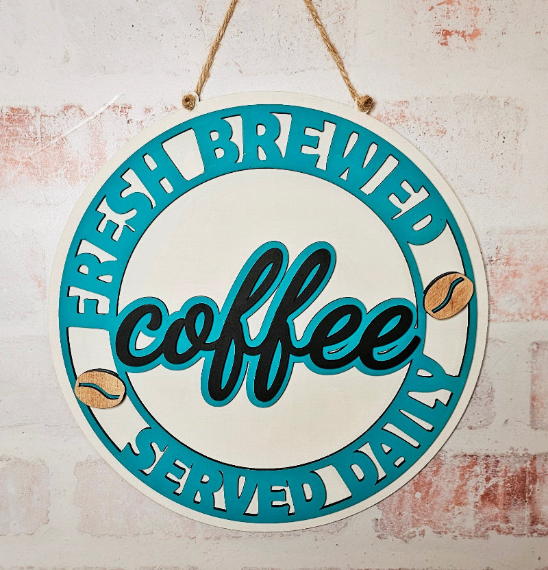 Circular sign with 'fresh brewed coffee' text on a textured wall background