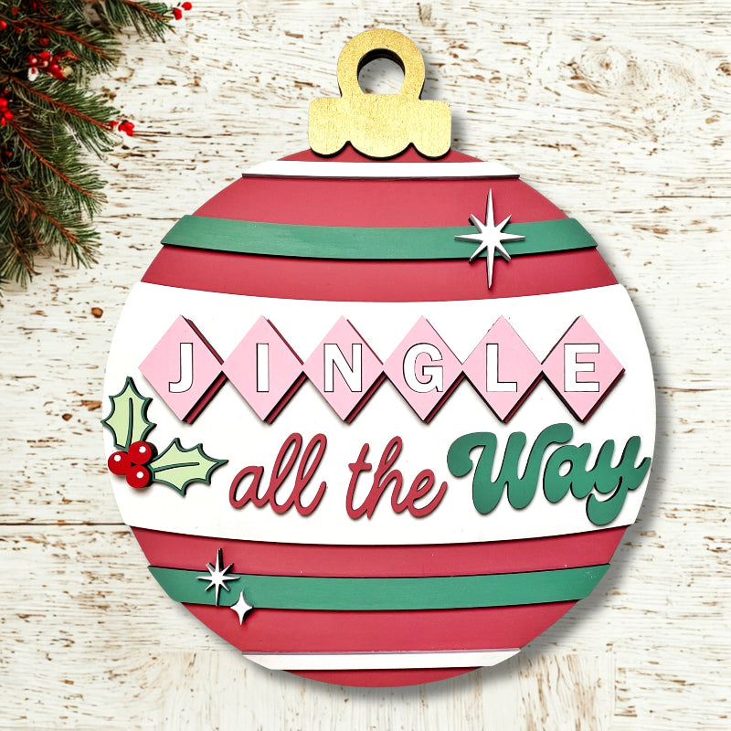 Decorative Christmas ornament with 'Jingle all the Way' text on a wooden background.