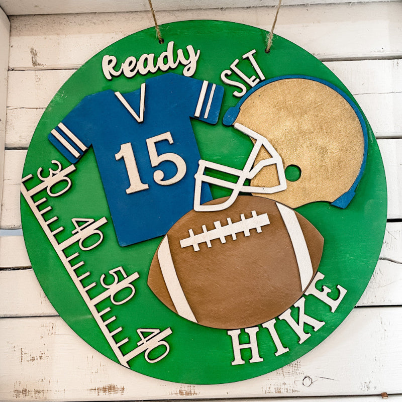 Decorative sign with football elements on a wooden background