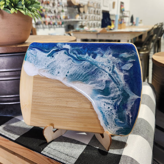 Wooden block with blue and white wave design on a checkered surface