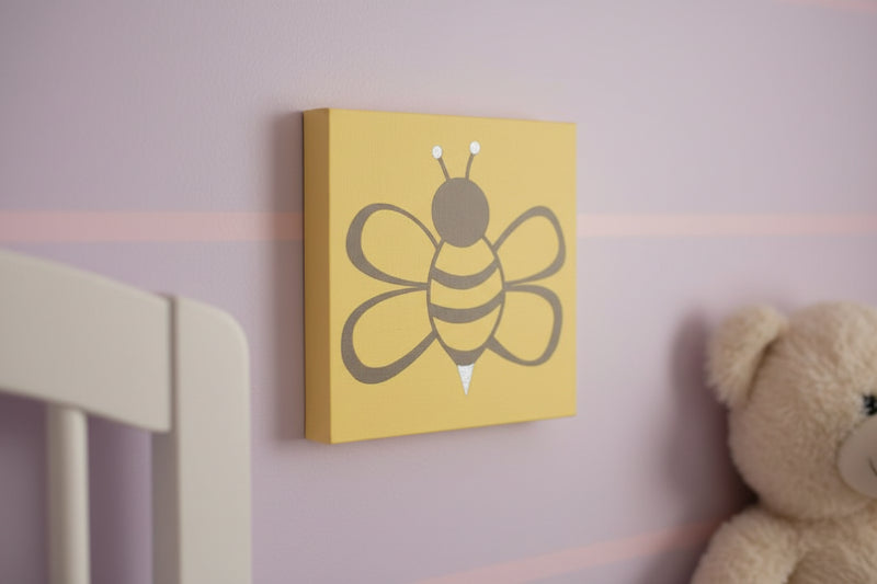 Large gray bumblebee painted onto a yellow square wood sign