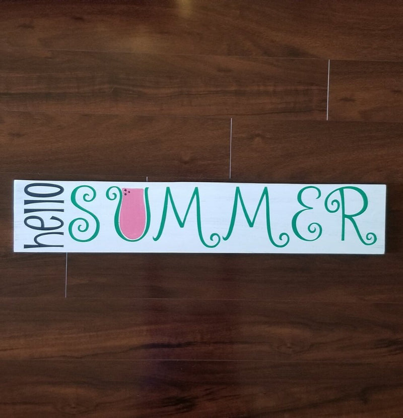 A plank design sign with the text 'Hello Summer' and a small graphic of a slice of watermelon.