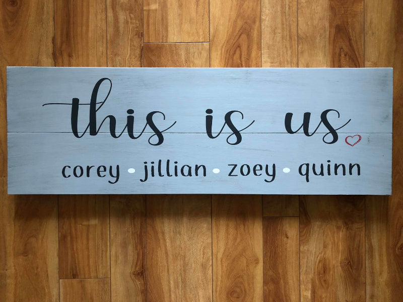 A personalized plank design plaque with the text 'This is Us' and names listed below the text.