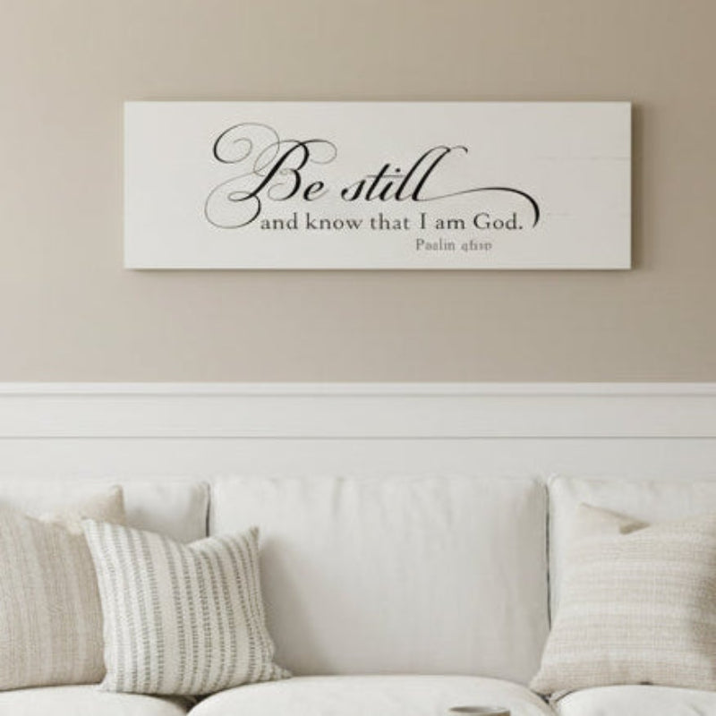 A white plank design with the text 'BE STILL AND KNOW THAT I AM GOD. PHIL. 4:10-11' printed in black.
