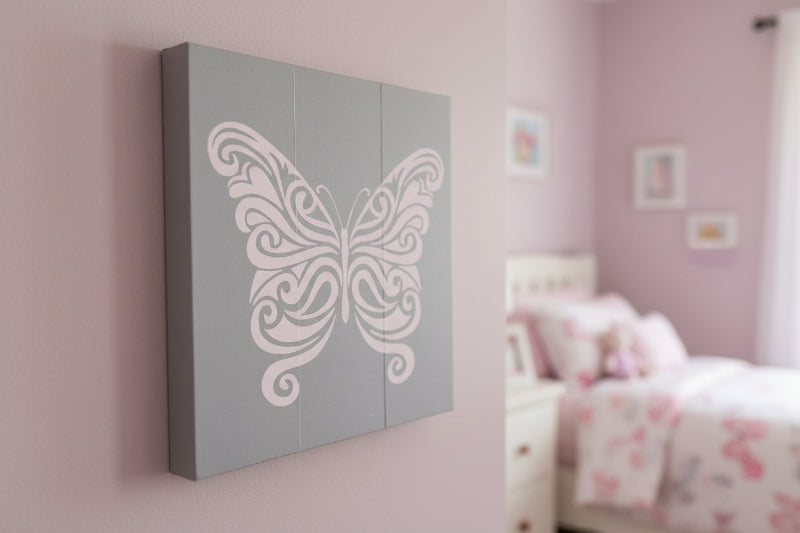 A square-shaped wall decor featuring a pink butterfly design with intricate patterns on its wings.