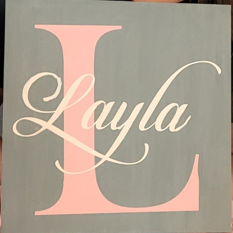 The Letter L with a name over the top on a gray background