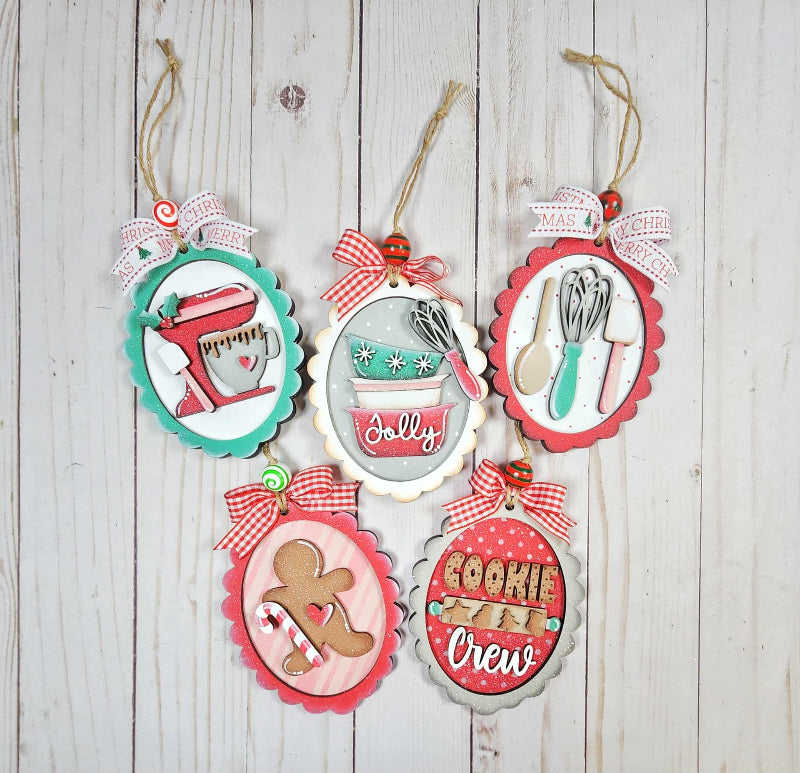Set of decorative Christmas ornaments with festive designs on a wooden surface.