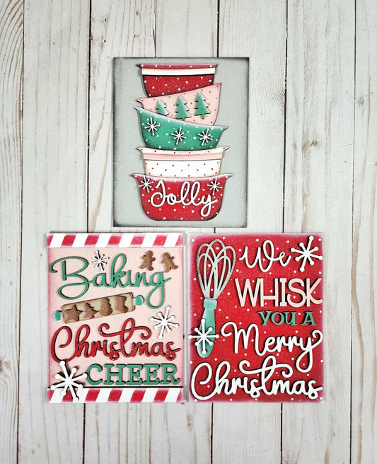 Set of Christmas-themed decorative signs on a wooden background