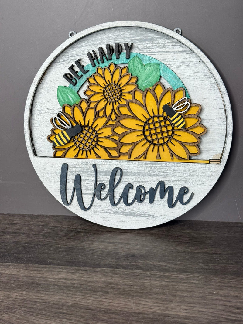 Decorative wall art with sunflowers and bees on a wooden background