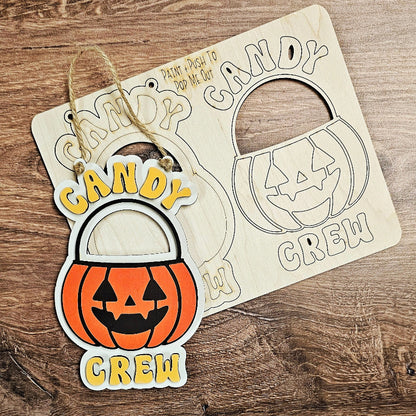 Halloween-themed 'Candy Crew' candy holder on a wooden surface