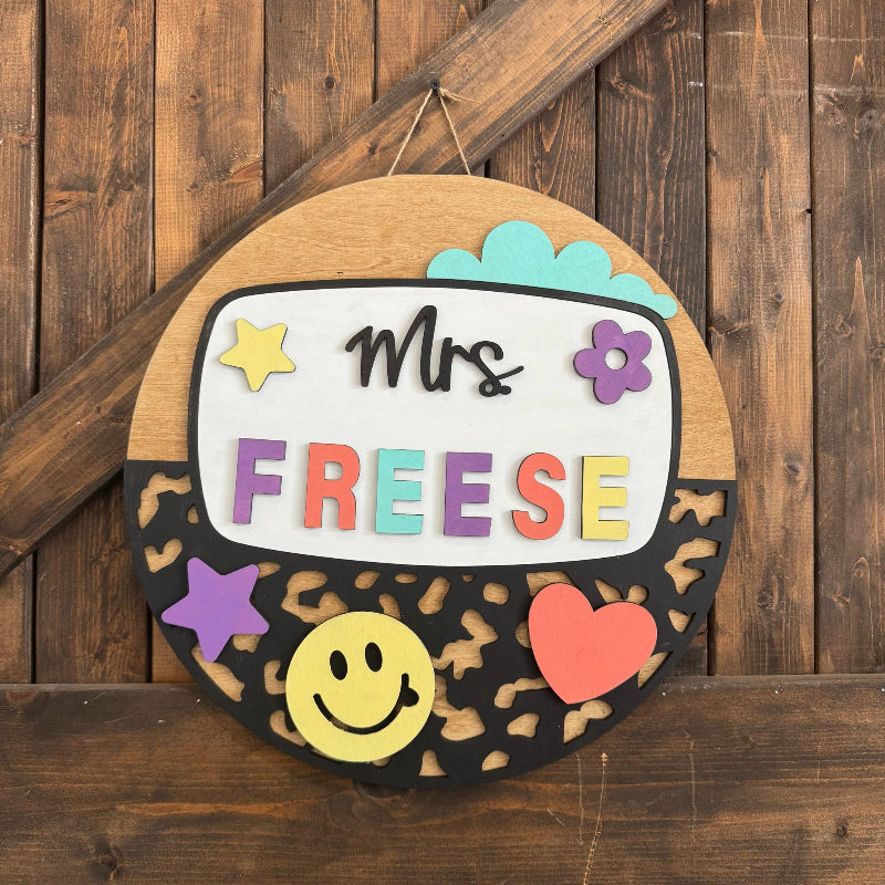 Decorative sign with 'Mrs. Freese' on a wooden background