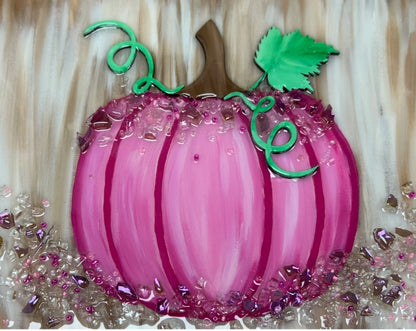 Decorative pink pumpkin with crushed glass decorative elements on a beige background