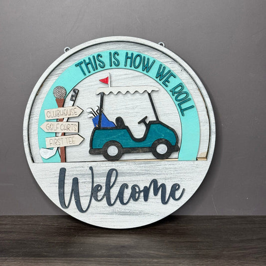 Decorative sign with golf cart and 'Welcome' text on a gray background