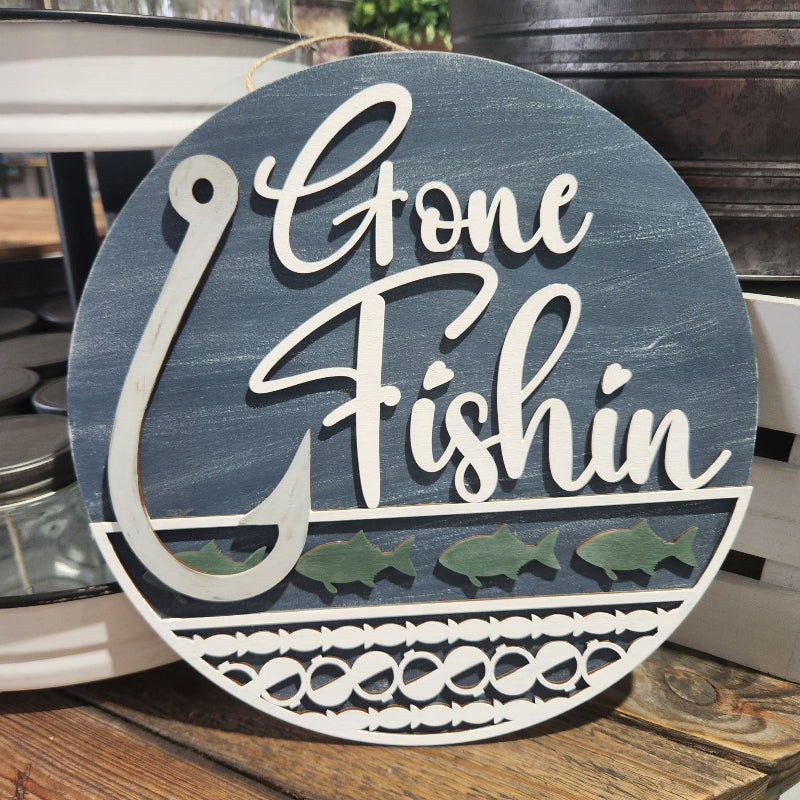 Decorative sign with 'Gone Fishin' text on a blue background