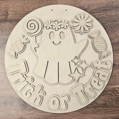 Wooden cutout with Halloween-themed design on a wooden surface