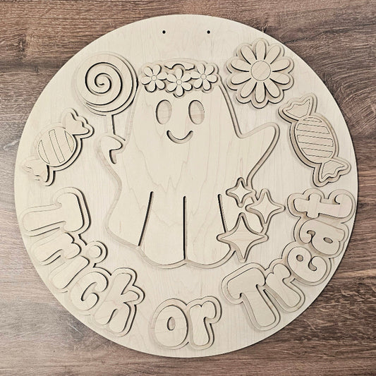 Wooden cutout with Halloween-themed design on a wooden surface