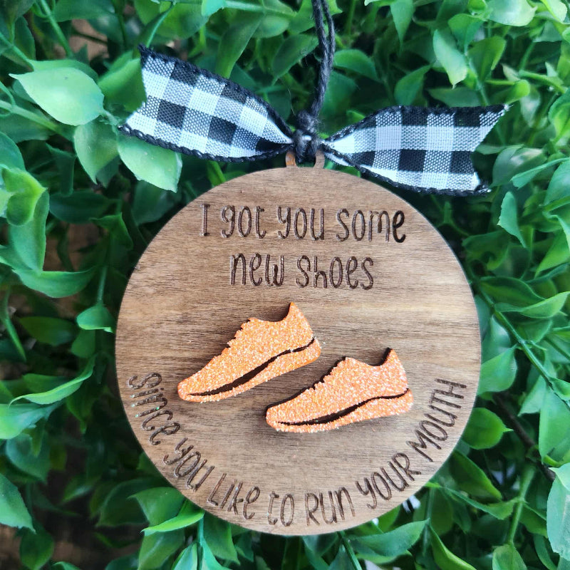 round wooden ornament with a pair of running shoes 
