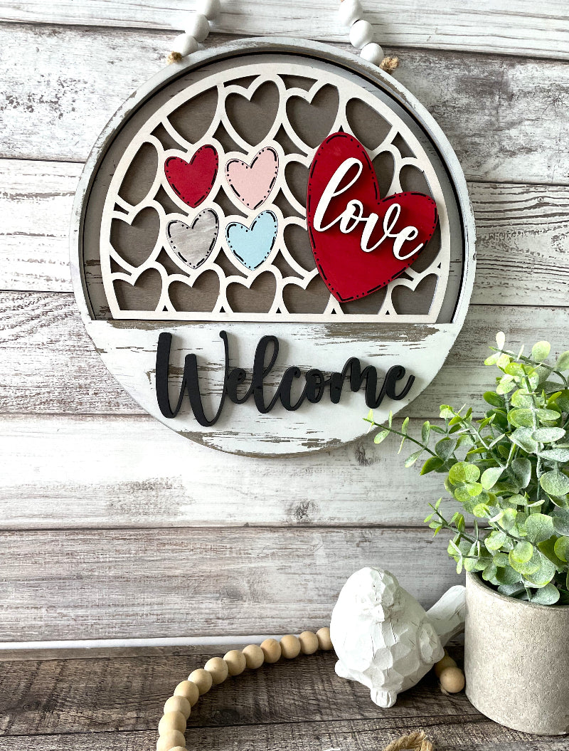 Love Hearts Valentine’s Day interchangeable wooden Welcome sign insert with layered red, pink and blue hearts, available at Painted Pallet Studio in St. Augustine, FL.