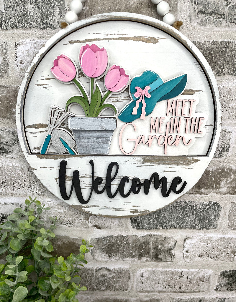 Meet Me in the Garden spring interchangeable wooden Welcome sign insert with pink tulips, garden tools, flowerpot and teal garden hat.