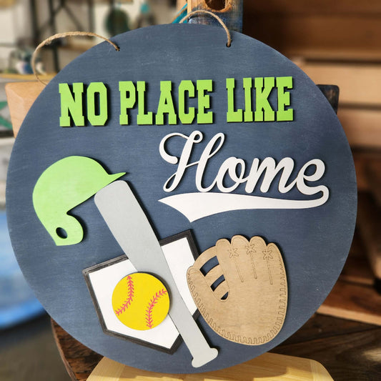 Decorative sign with sports-themed elements and 'No Place Like Home' text.