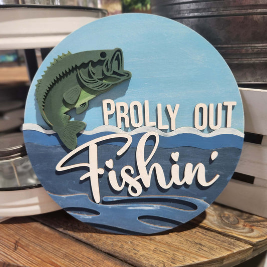 Decorative sign with a fish illustration and text 'Prolly Out Fishin'' on a blue background.
