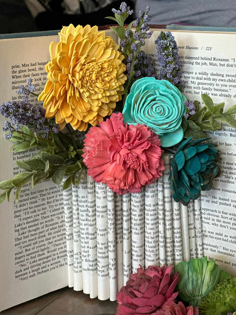 Colorful flower arrangement on an open book