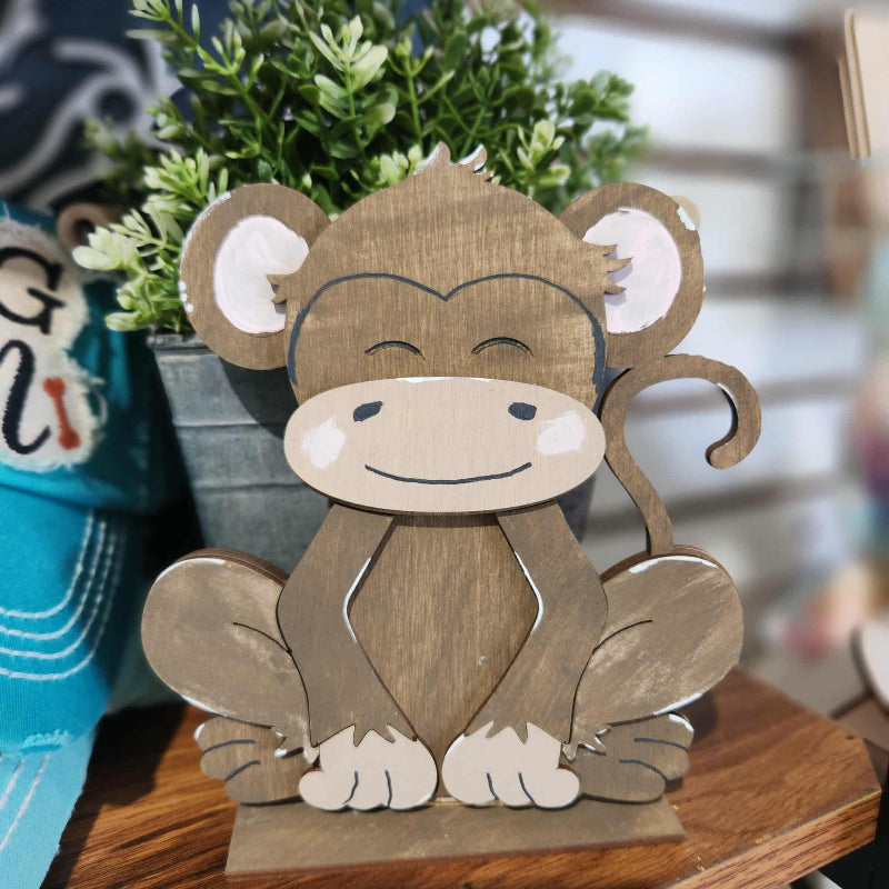 7 inch wooden monkey sitting on a base . perfect for all ages as a diy craft