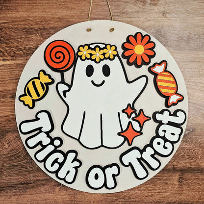 Circular Halloween-themed sign with a ghost, candies, and 'Trick or Treat' text on a wooden background.