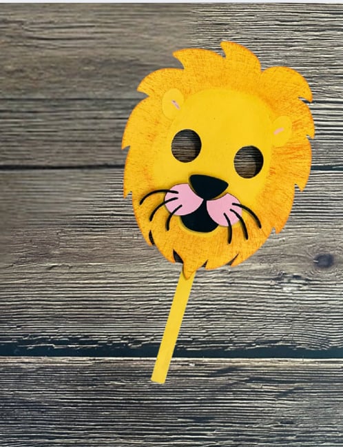 Yellow lion mask on a wooden background