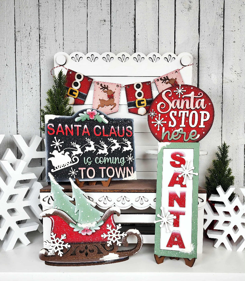Collection of Christmas-themed decorative signs on a wooden background