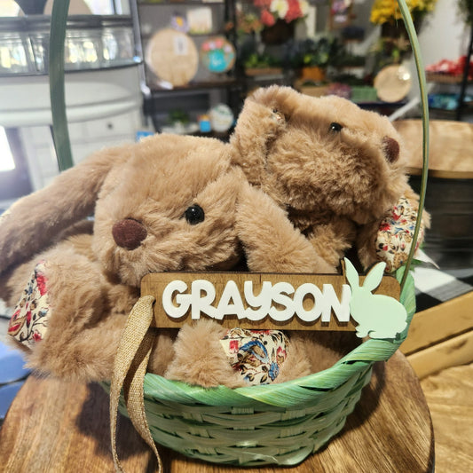 Easter bunnies in a basket with a 'Grayson' sign in a store setting