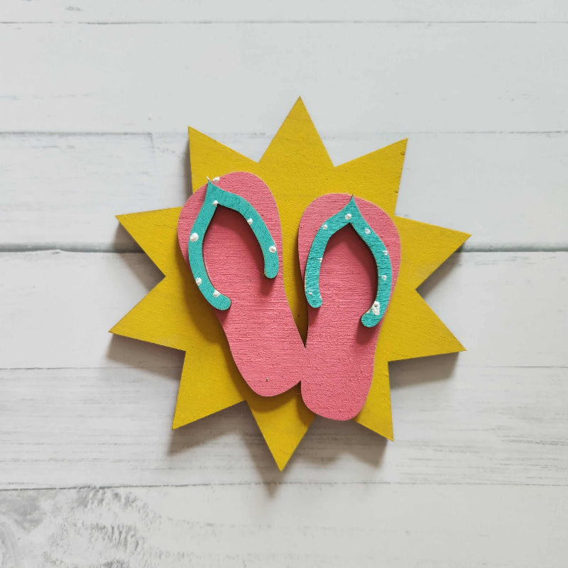 Decorative pink flip flops design on a yellow star-shaped background