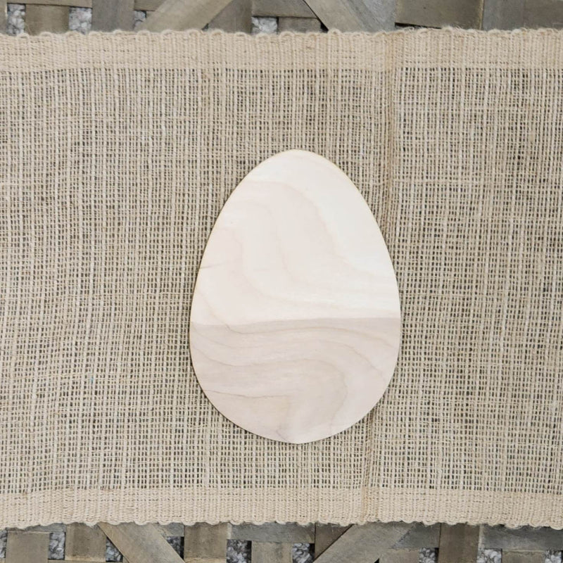 A wooden cutout in the shape of an egg